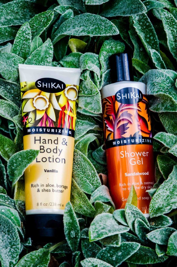 ShiKai Vanilla Hand & Body Lotion with ShiKai Sandalwood Shower Gel laying in leaves.